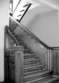 A grand staircase in the New Delphos Manufacturing office building .